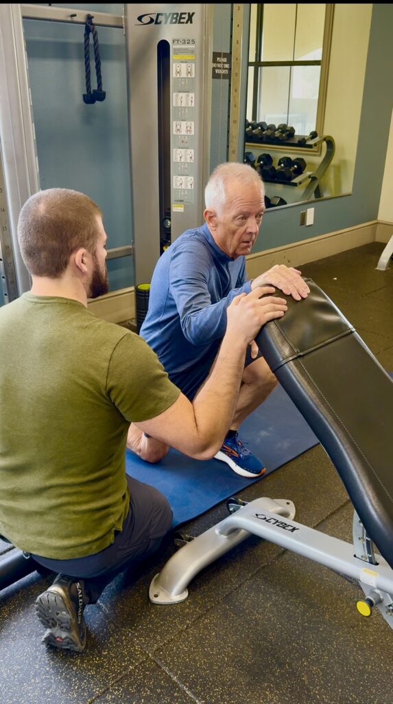 Personal trainer working with a senior