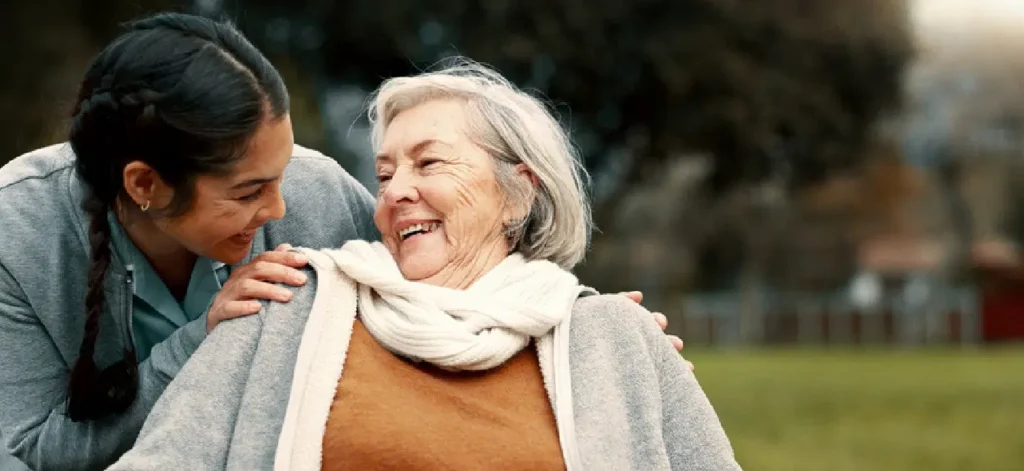 Senior woman smiling at young woman.