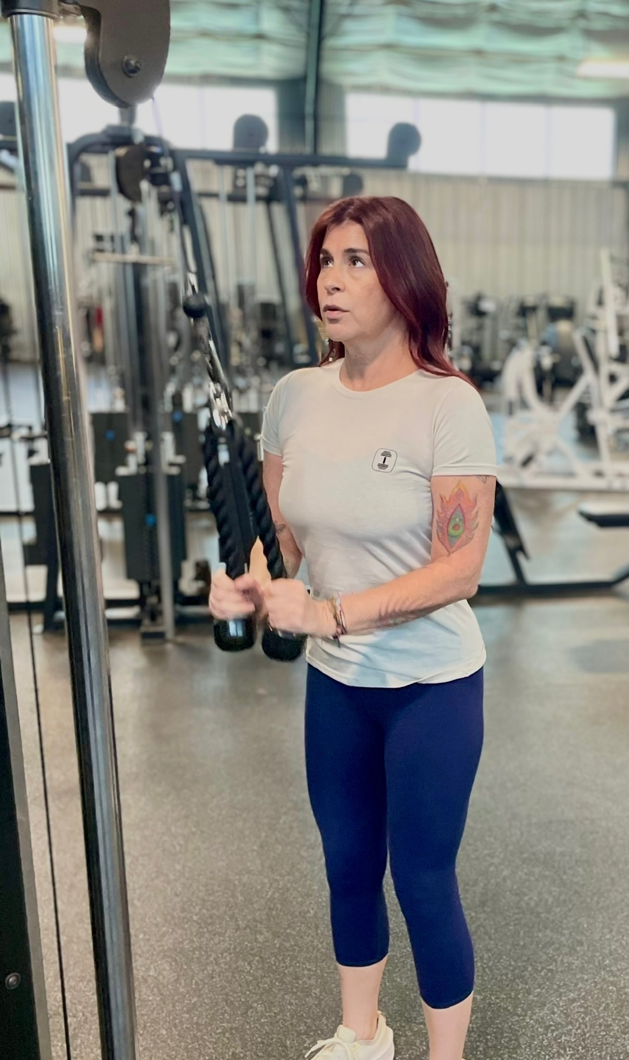 Sarah a senior personal trainer in San Antonio in a gym doing tricep exercises