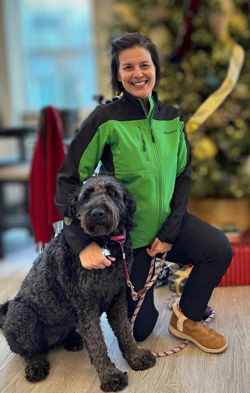 Personal Trainer for Seniors in Portland kneeling with a black dog