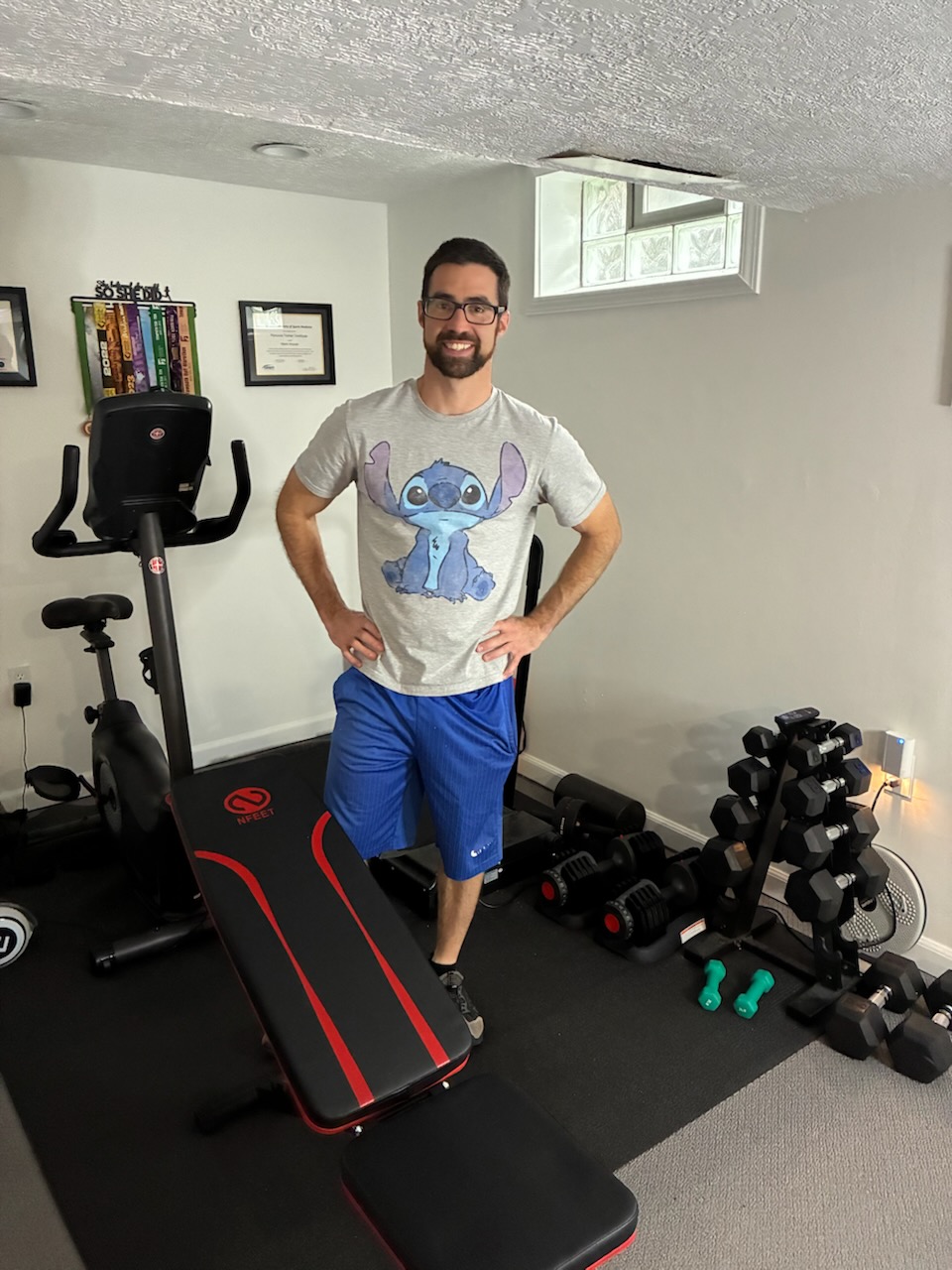 An ElderFIT trainer pictured standing in a home gym illustrates his availability to provide personal training for seniors in Cleveland.