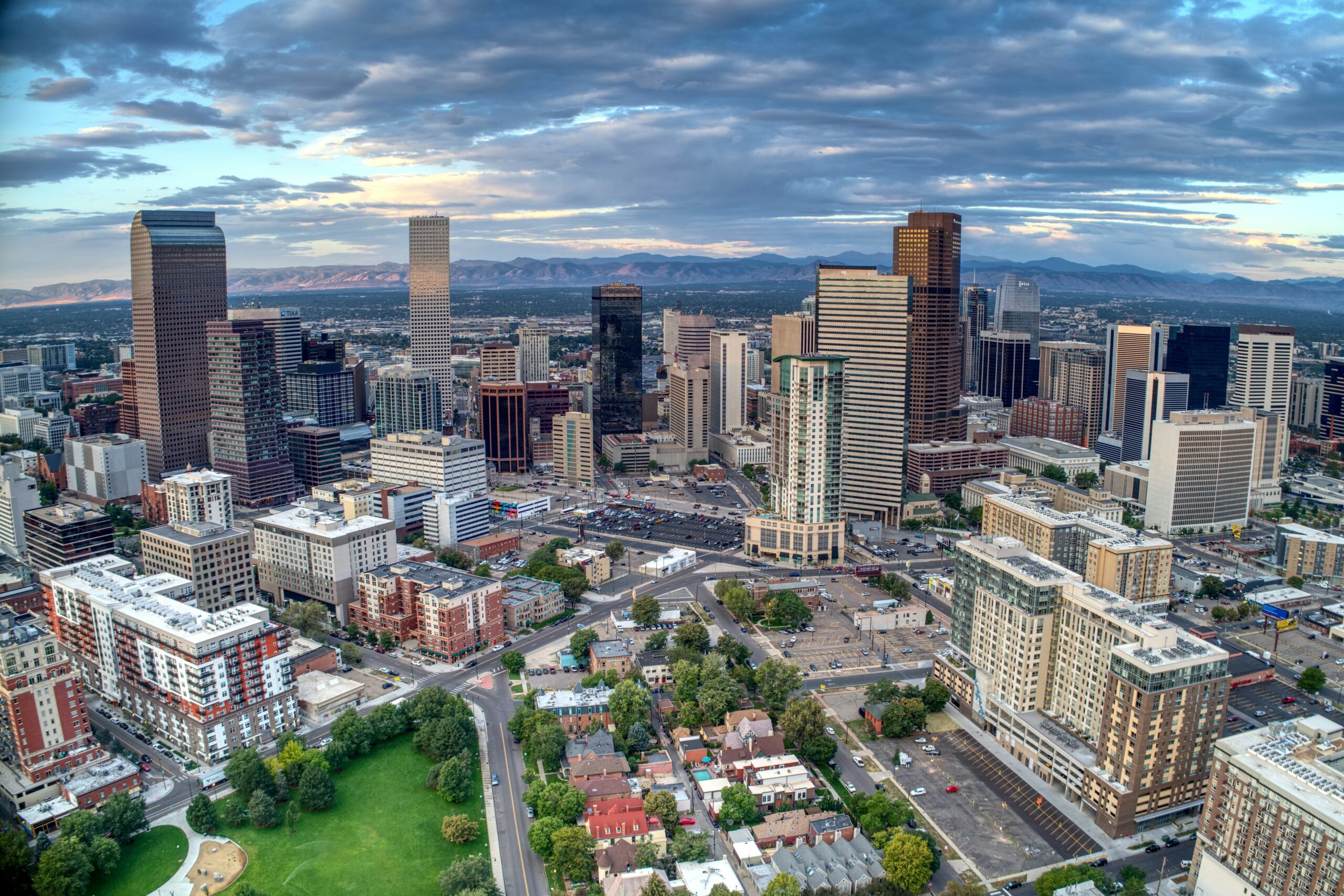 Picture of downtown Denver with the mountains in the distance for an article about personal trainers for seniors in Denver.
