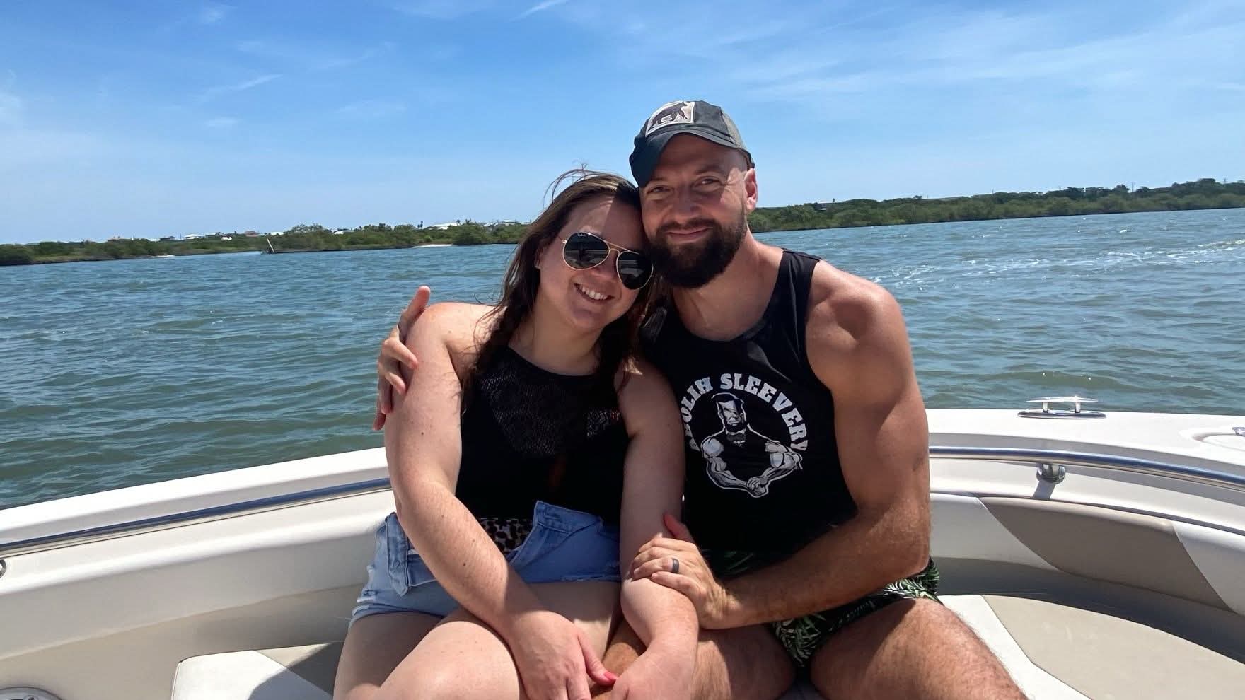 Picture of Macy and his wife on a boat hugging with the water behind them; Macy is a top personal trainer for seniors in Jacksonville.