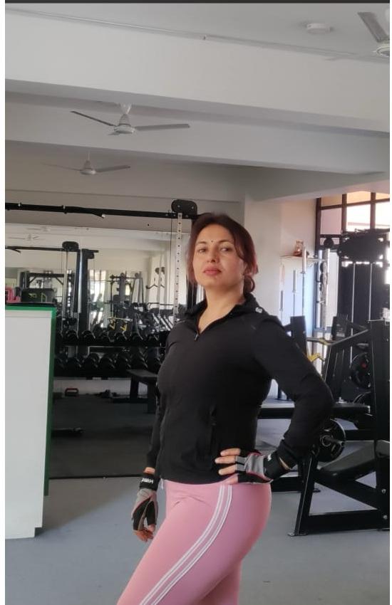 Picture of Sujata, a top ElderFIT personal trainer for seniors in Queens, with her arms on her hips and smiling