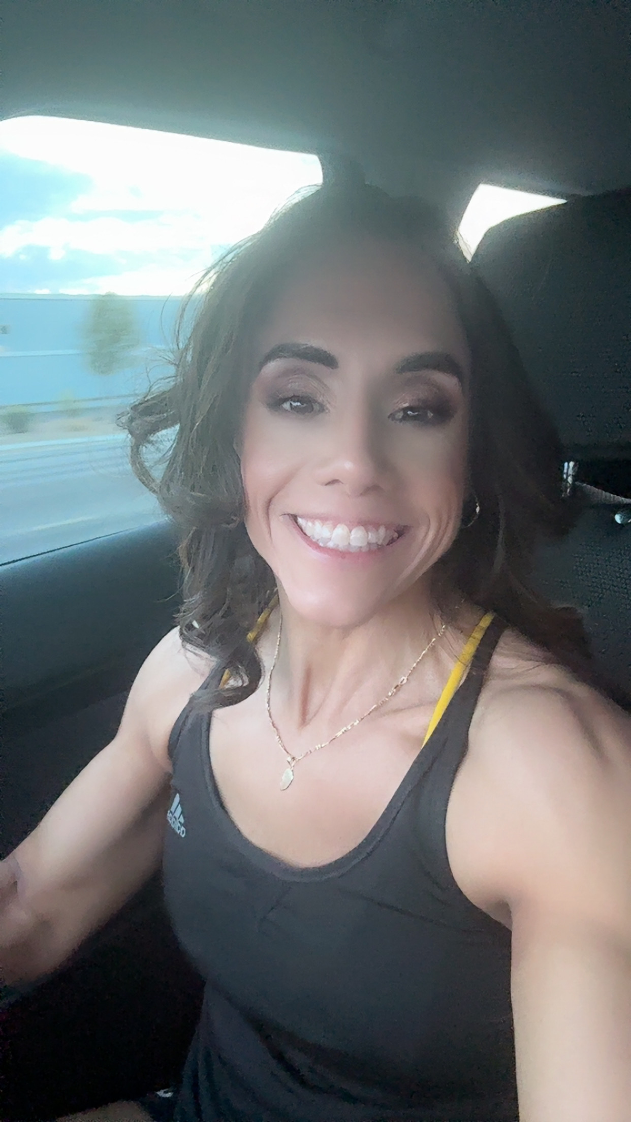 Pic of Yanez smiling in a car; Yanez is an ElderFIT top personal trainer for seniors in Las Vegas